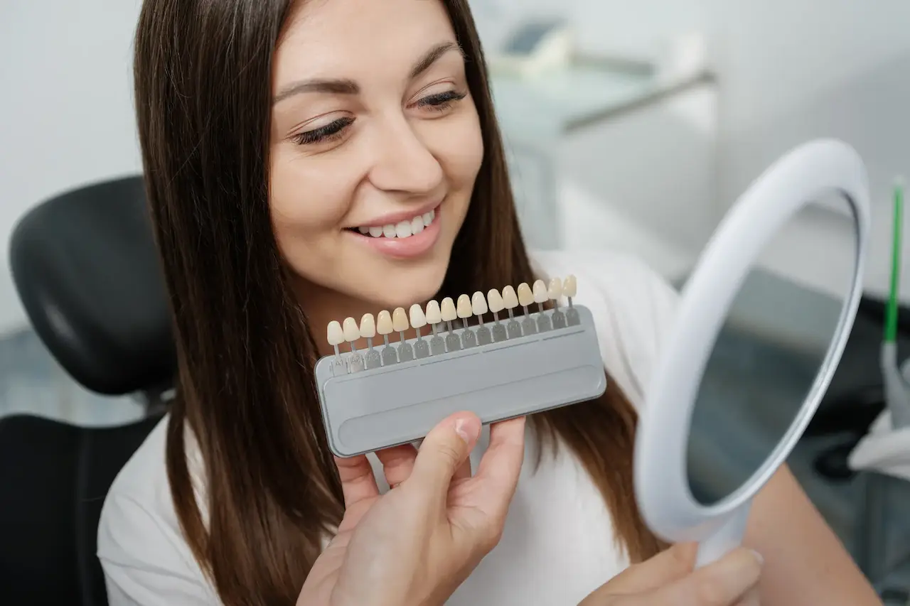 5 Reasons Veneers Are The Makeover, Dentist Comparing The Color of the Veneers on The Patients Teeth